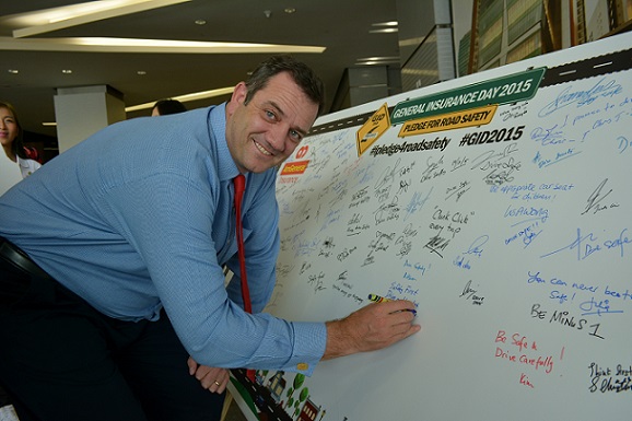 Roberts signing his name on the pledge